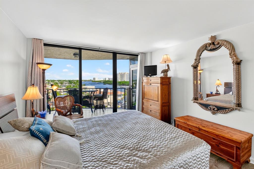 899 Jeffery Street, Unit 710 Boca Raton, FL 33487 - Photo 20 of 44 a bedroom with a bed and large windows