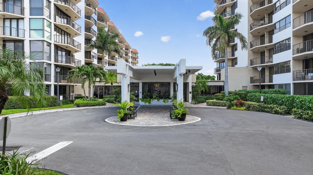 899 Jeffery Street, Unit 710 Boca Raton, FL 33487 - Photo 5 of 44 a view of brick building with a yard and large trees
