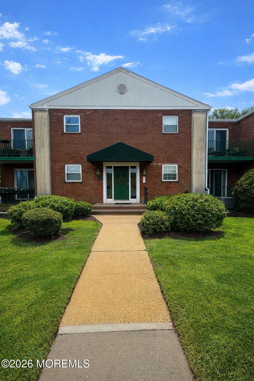 65 Cedar Avenue, Unit B2 Long Branch, NJ 07740 - Photo 1 of 8 a front view of a house with garden