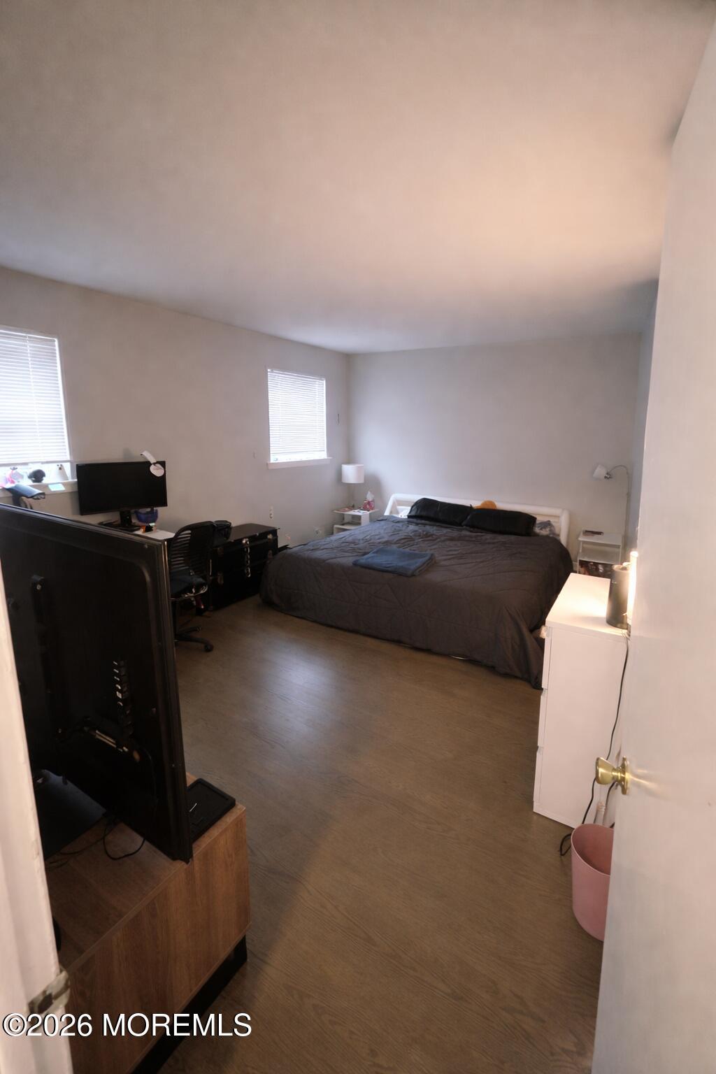 65 Cedar Avenue, Unit B2 Long Branch, NJ 07740 - Photo 2 of 8 a living room with furniture and a flat screen tv