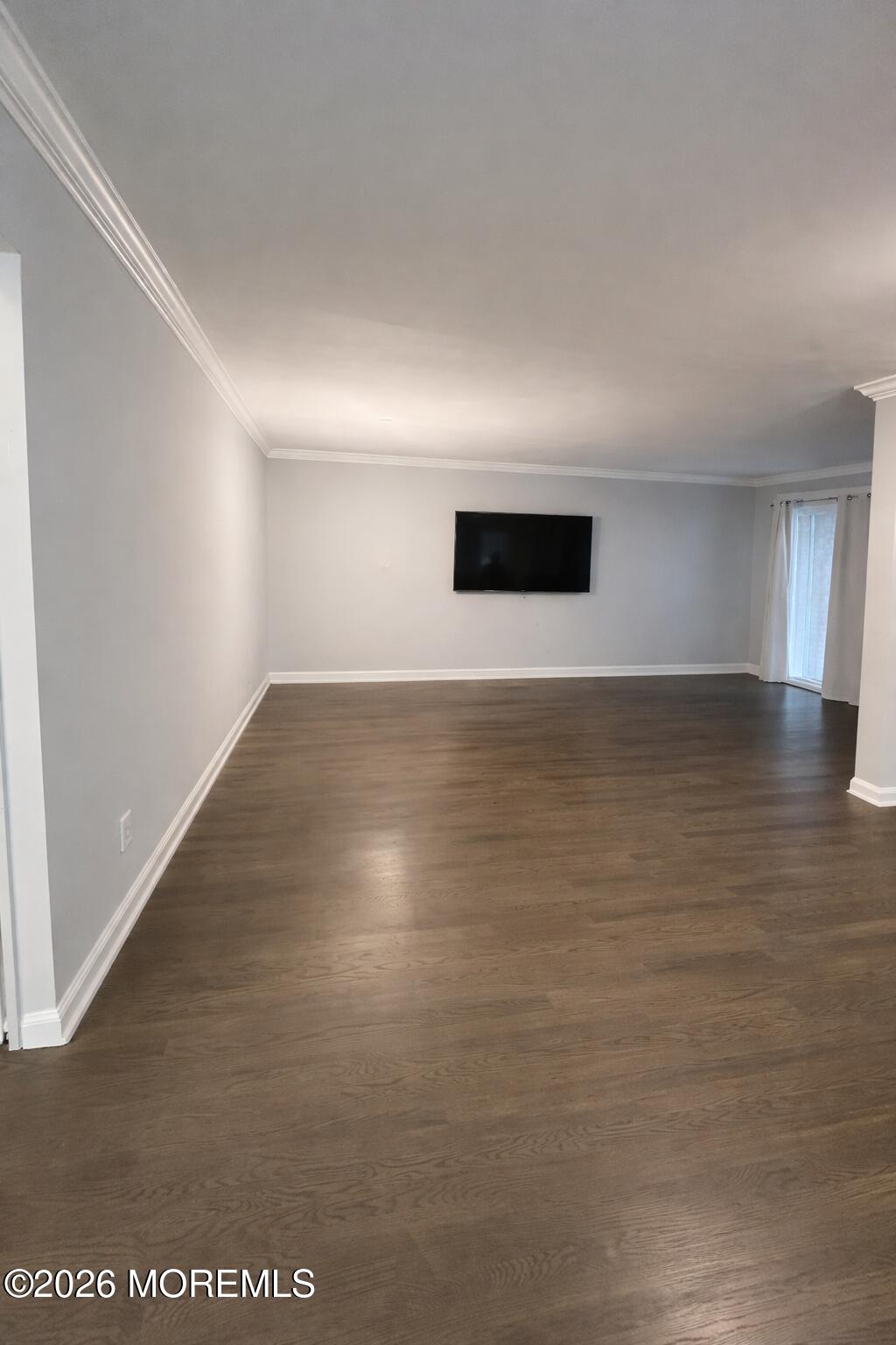 65 Cedar Avenue, Unit B2 Long Branch, NJ 07740 - Photo 3 of 8 a view of an empty room with wooden floor