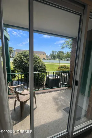 a balcony with chairs and ocean view