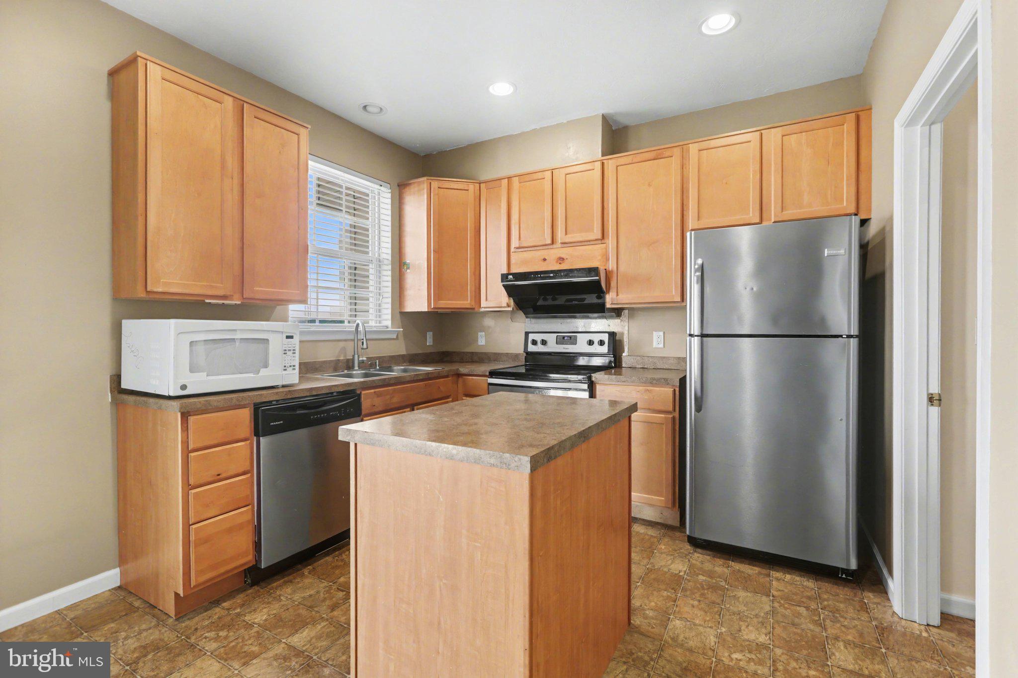 335 Cape Climb York, PA 17408 - Photo 12 of 34 Modern kitchen with warm wood tones.