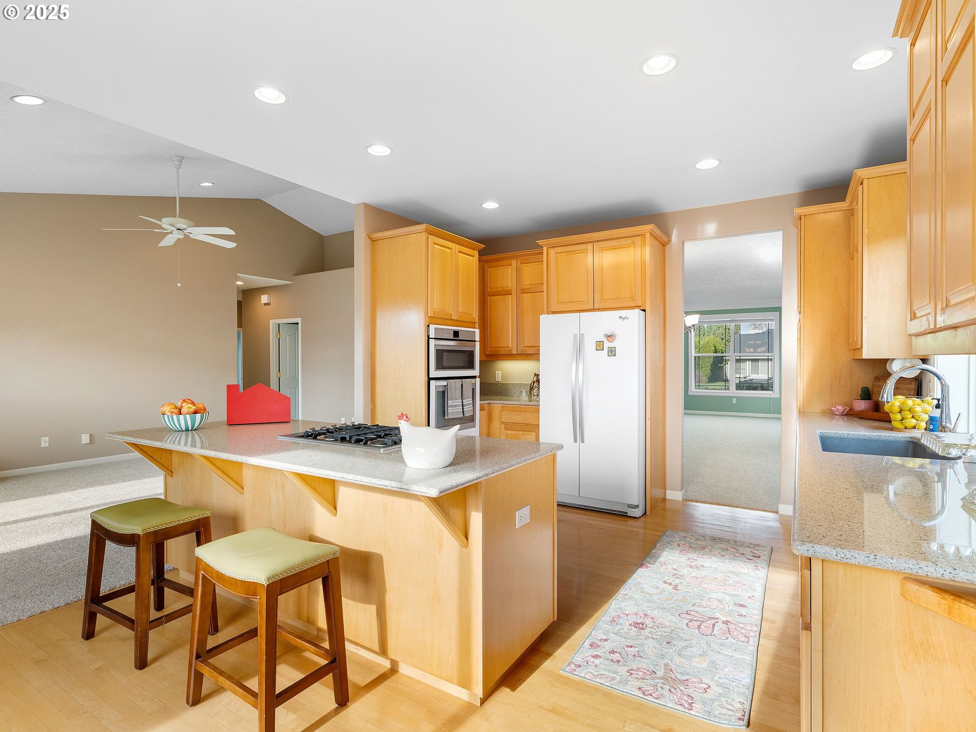 3956 Southeast 30th Street Gresham, OR 97080 - Photo 13 of 48 a kitchen with stainless steel appliances kitchen island granite countertop a refrigerator and a stove