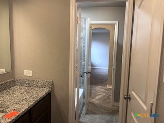 861 Stockdale Road Copperas Cove, TX 76522 - Photo 12 of 35 a bathroom with a granite countertop sink and a mirror