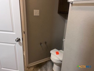 861 Stockdale Road Copperas Cove, TX 76522 - Photo 13 of 35 a white toilet sitting next to a bathroom sink