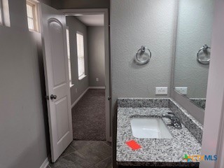 861 Stockdale Road Copperas Cove, TX 76522 - Photo 21 of 35 a bathroom with a granite countertop sink a mirror and vanity
