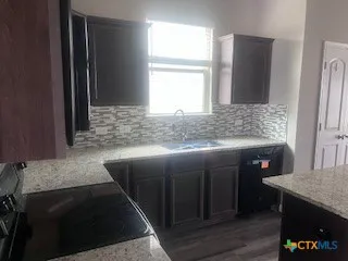 a bathroom with a tub a sink and a mirror