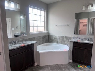 861 Stockdale Road Copperas Cove, TX 76522 - Photo 10 of 35 a bathroom with a tub a sink and a mirror