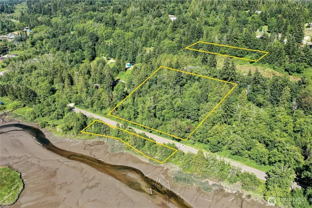 a view of a yard with a wooden fence