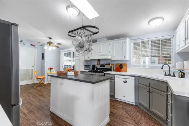 a kitchen with stainless steel appliances a sink and cabinets