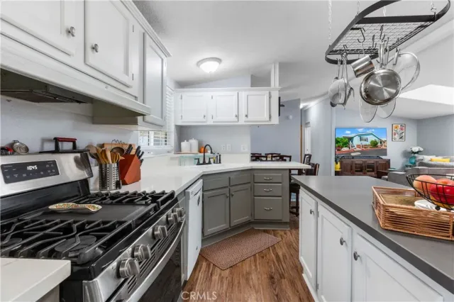 a kitchen with a stove and a white cabinets