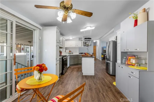 a living room with stainless steel appliances kitchen island granite countertop furniture and a kitchen view