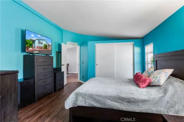 a bedroom with a bed and a flat screen tv