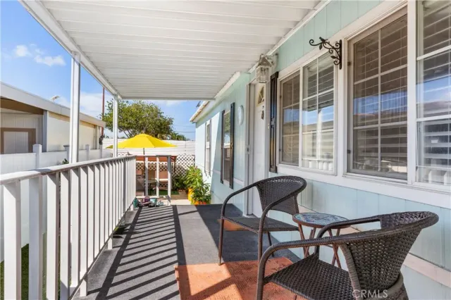 a view of balcony with furniture and wooden floor