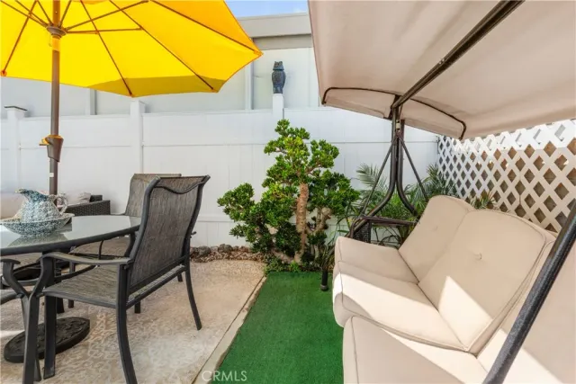 a view of a chair and table in the backyard