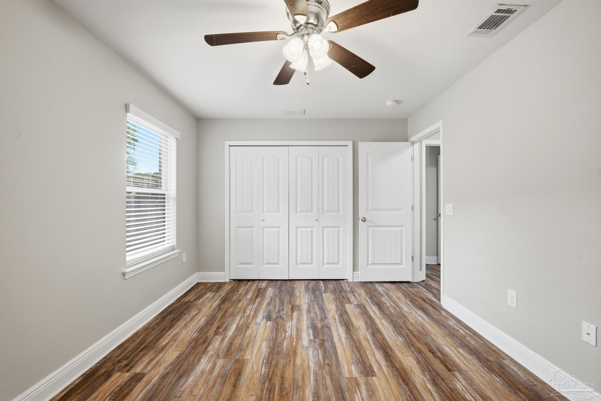 5661 Cane Syrup Circle Pace, FL 32571 - Photo 15 of 20 a view of empty room with wooden floor and fan
