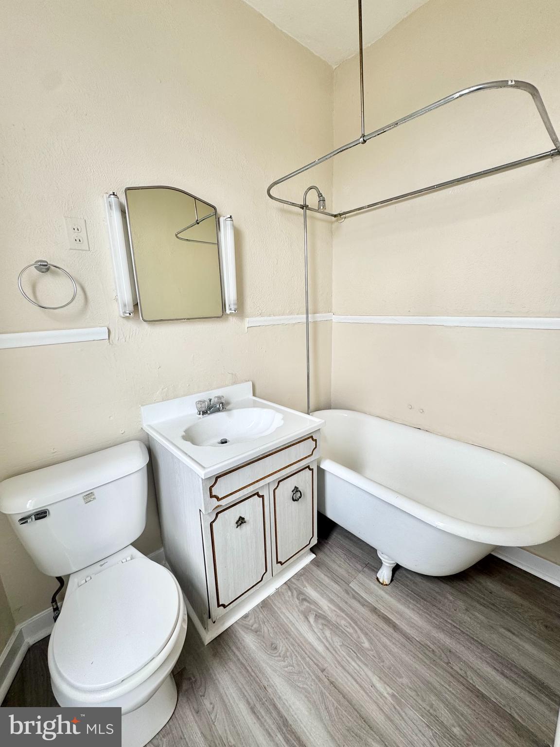 5040 Walnut Street, Unit 3R Philadelphia, PA 19139 - Photo 7 of 9 a bathroom with a toilet sink and mirror