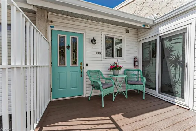 a view of a porch with a table and chairs