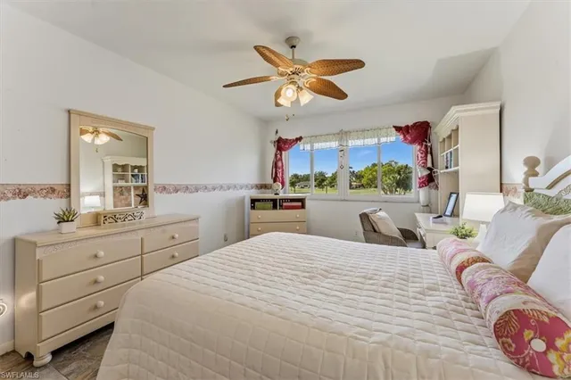 a bedroom with a bed and ceiling fan