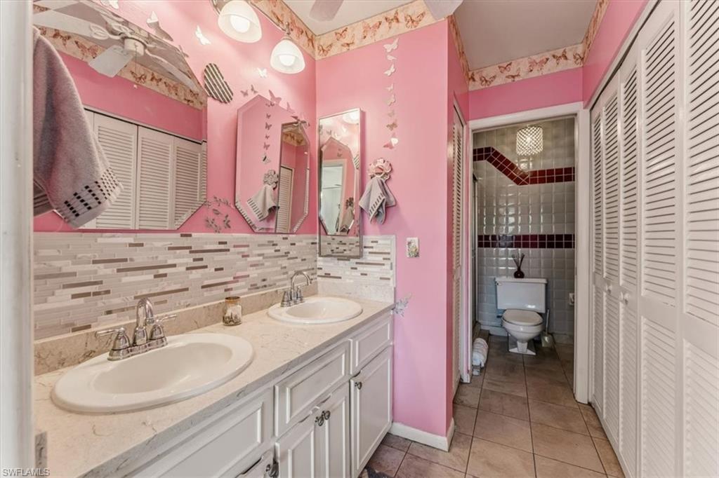 492 Bristle Cone Lane, Unit 47 Naples, FL 34113 - Photo 14 of 21 a bathroom with a sink vanity and a mirror