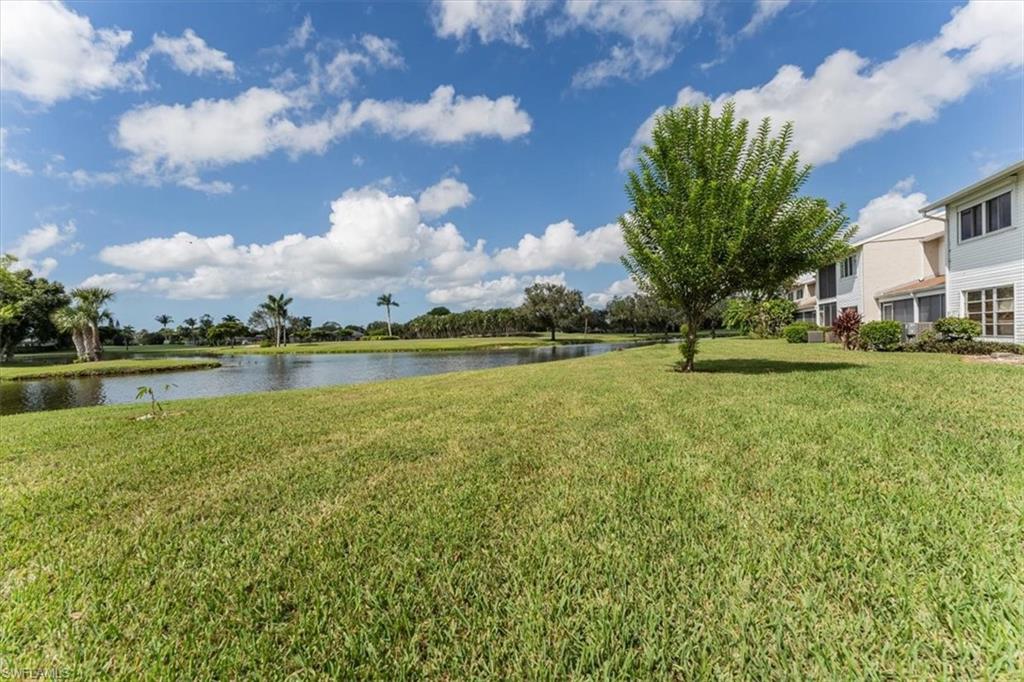 492 Bristle Cone Lane, Unit 47 Naples, FL 34113 - Photo 21 of 21 a view of a lake with houses in the background