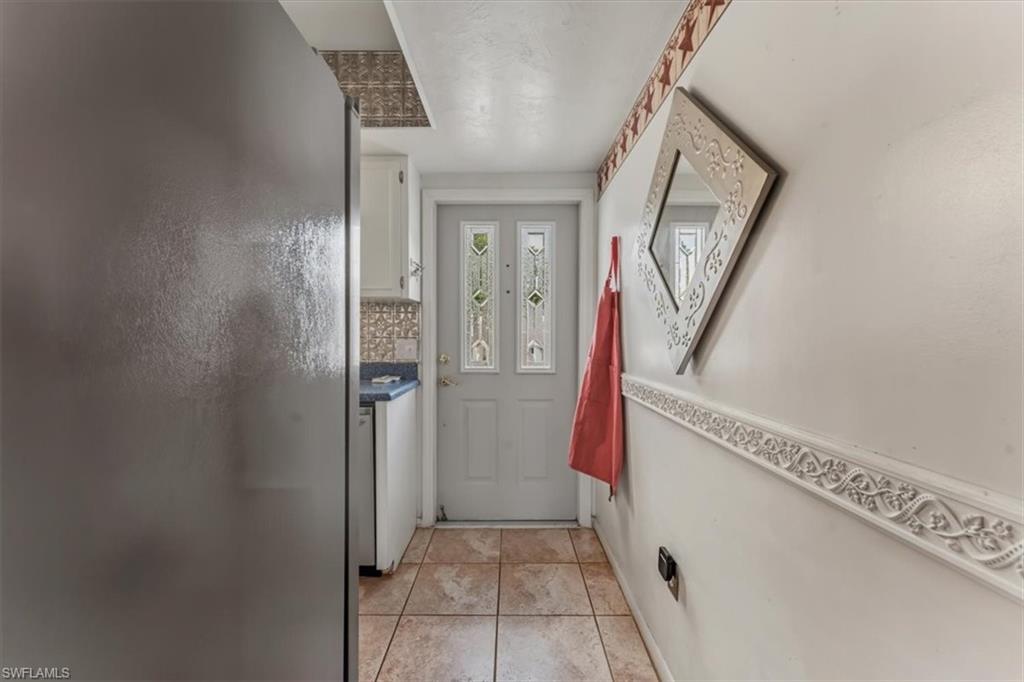 492 Bristle Cone Lane, Unit 47 Naples, FL 34113 - Photo 4 of 21 a view of a hallway with wooden floor and entryway