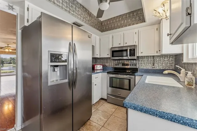 a kitchen with granite countertop a refrigerator and a sink