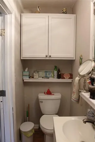 a bathroom with a toilet a sink and a window