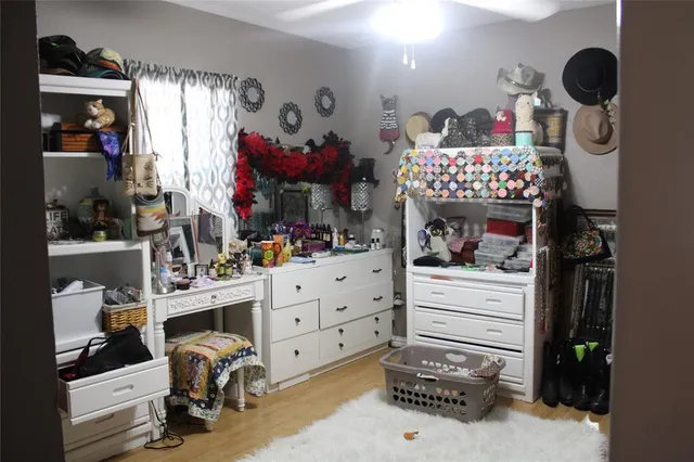 a room with a baby crib furniture and a window
