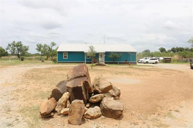 a view of a swimming pool with a lawn chairs under an umbrella