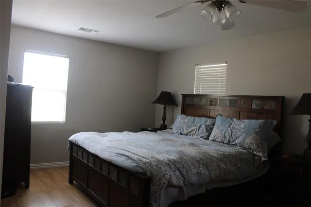 a bedroom with a bed and a window