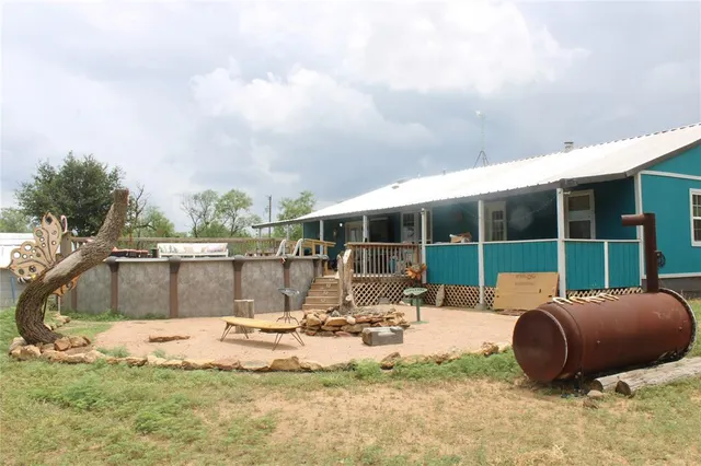 a balcony with wooden floor and outdoor seating