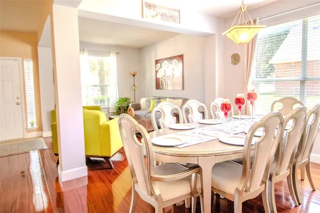 a dining room with furniture and window