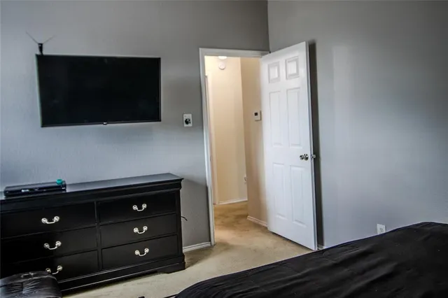 a bedroom with a bed and cabinets