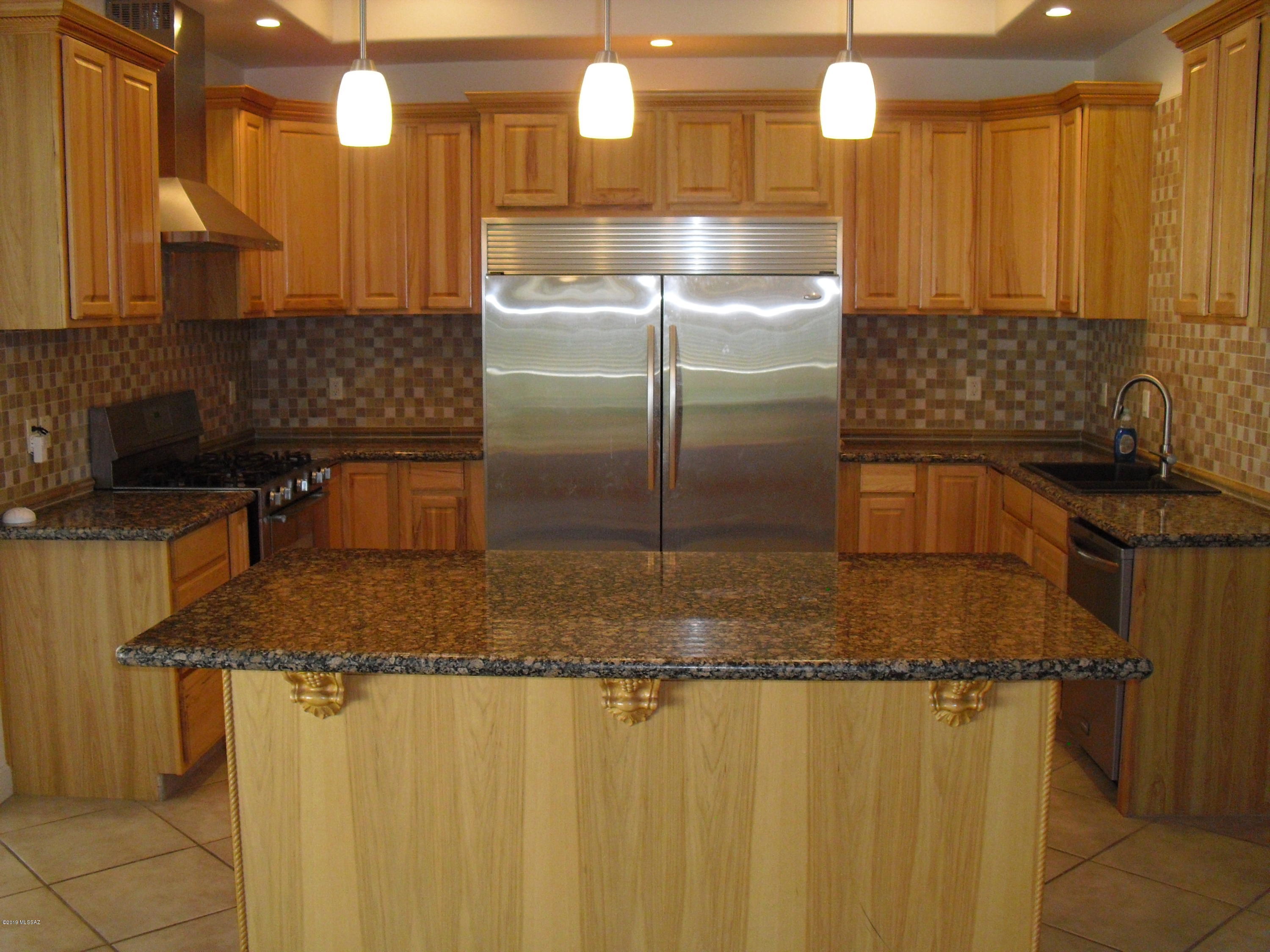 402 Hopkins Street Rio Rico, AZ 85648 - Photo 4 of 14 a kitchen with stainless steel appliances granite countertop a sink a stove and a refrigerator