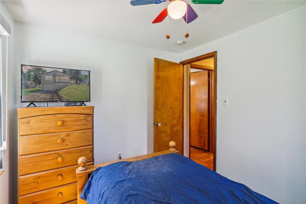1616 Glenbrook Avenue Coraopolis, PA 15108 - Photo 22 of 31 a bedroom with a bed and wooden floor