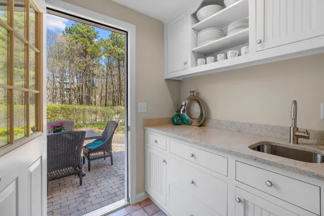 a kitchen with stainless steel appliances white cabinets and a table