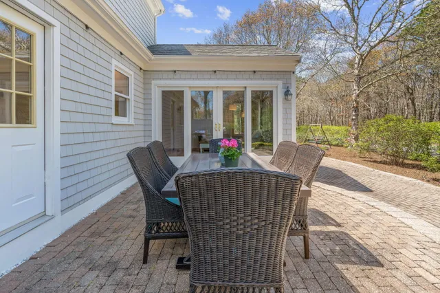 a view of a patio with a table and chairs