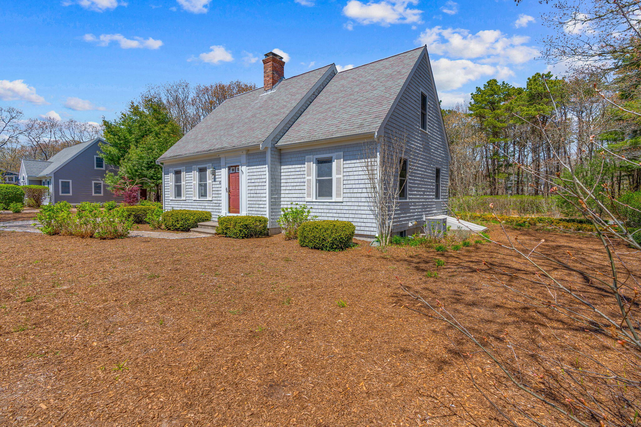 43 Neshobe Road Mashpee, MA 02649 - Photo 3 of 48 a front view of house with yard and trees around