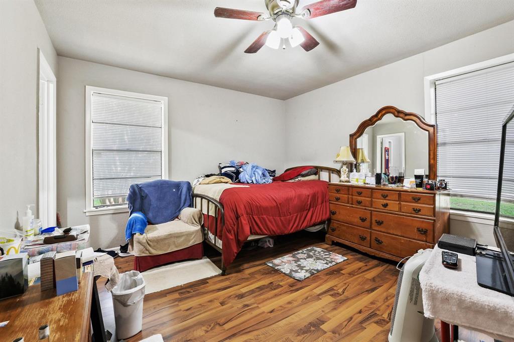 606 Hunter Street Bonham, TX 75418 - Photo 10 of 15 a bedroom with a bed and wooden floor