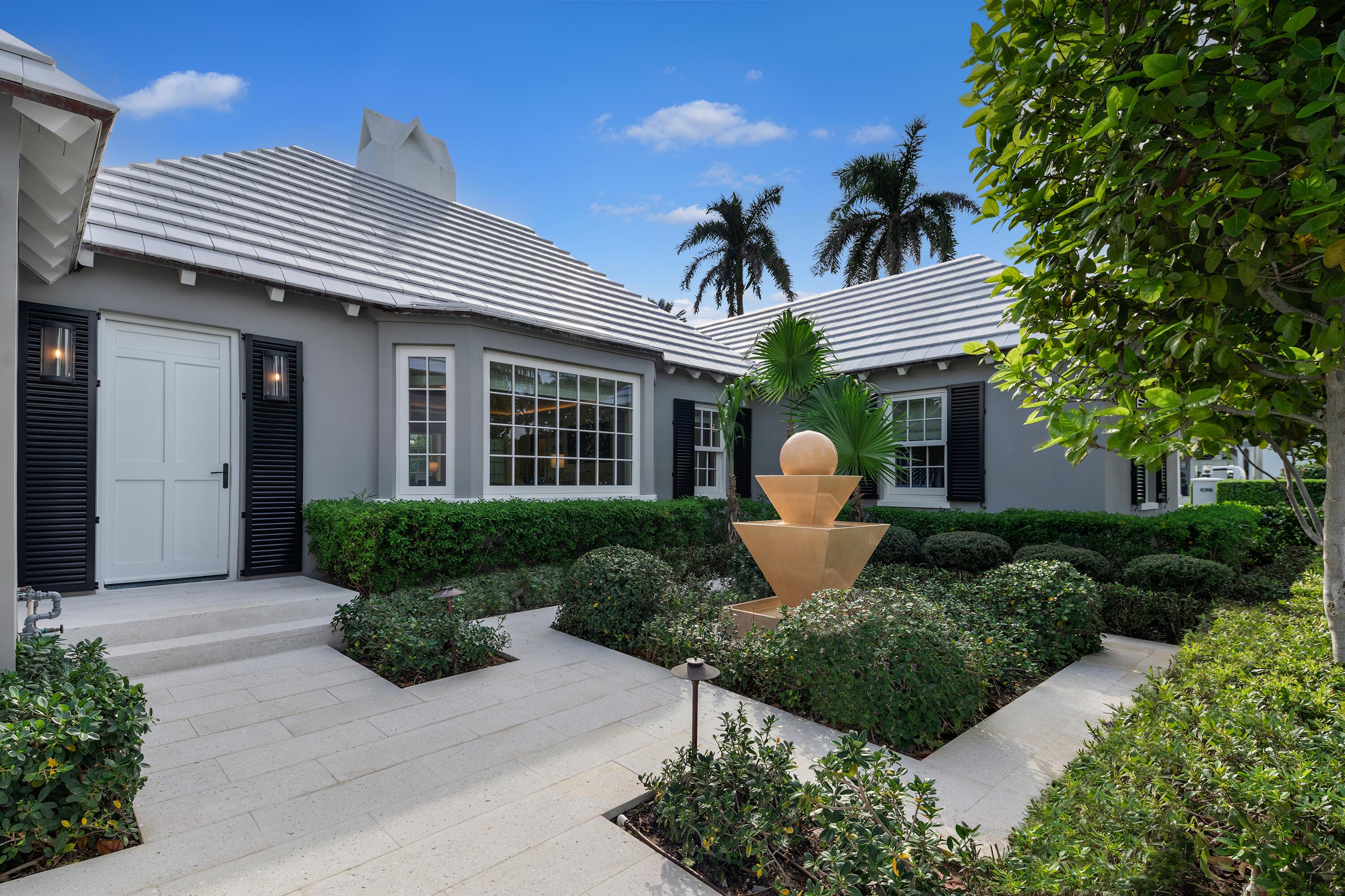 284 Monterey Road Palm Beach, FL 33480 - Photo 18 of 21 a front view of a house with a yard garage and outdoor seating