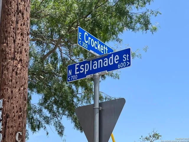 a street sign on a pole on a wall