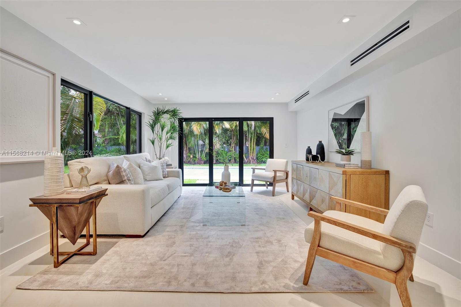 4321 Alton Road Miami Beach, FL 33140 - Photo 13 of 56 a living room with furniture and a large window