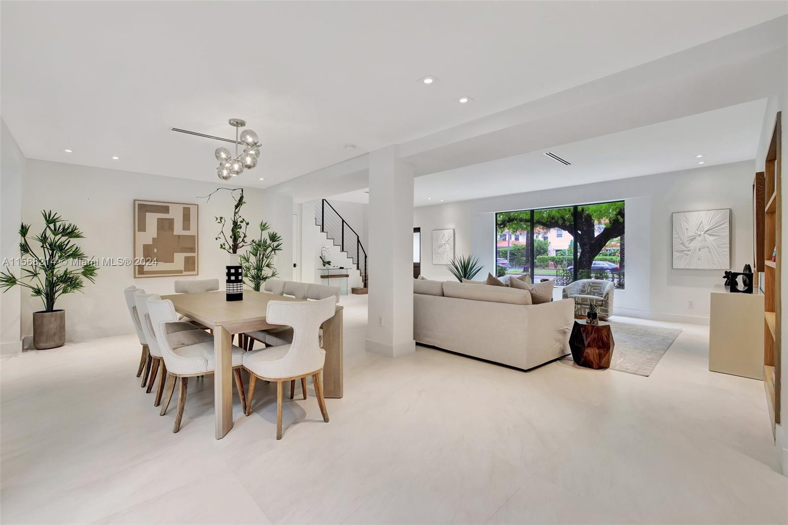 4321 Alton Road Miami Beach, FL 33140 - Photo 14 of 56 a dining room with furniture and a chandelier