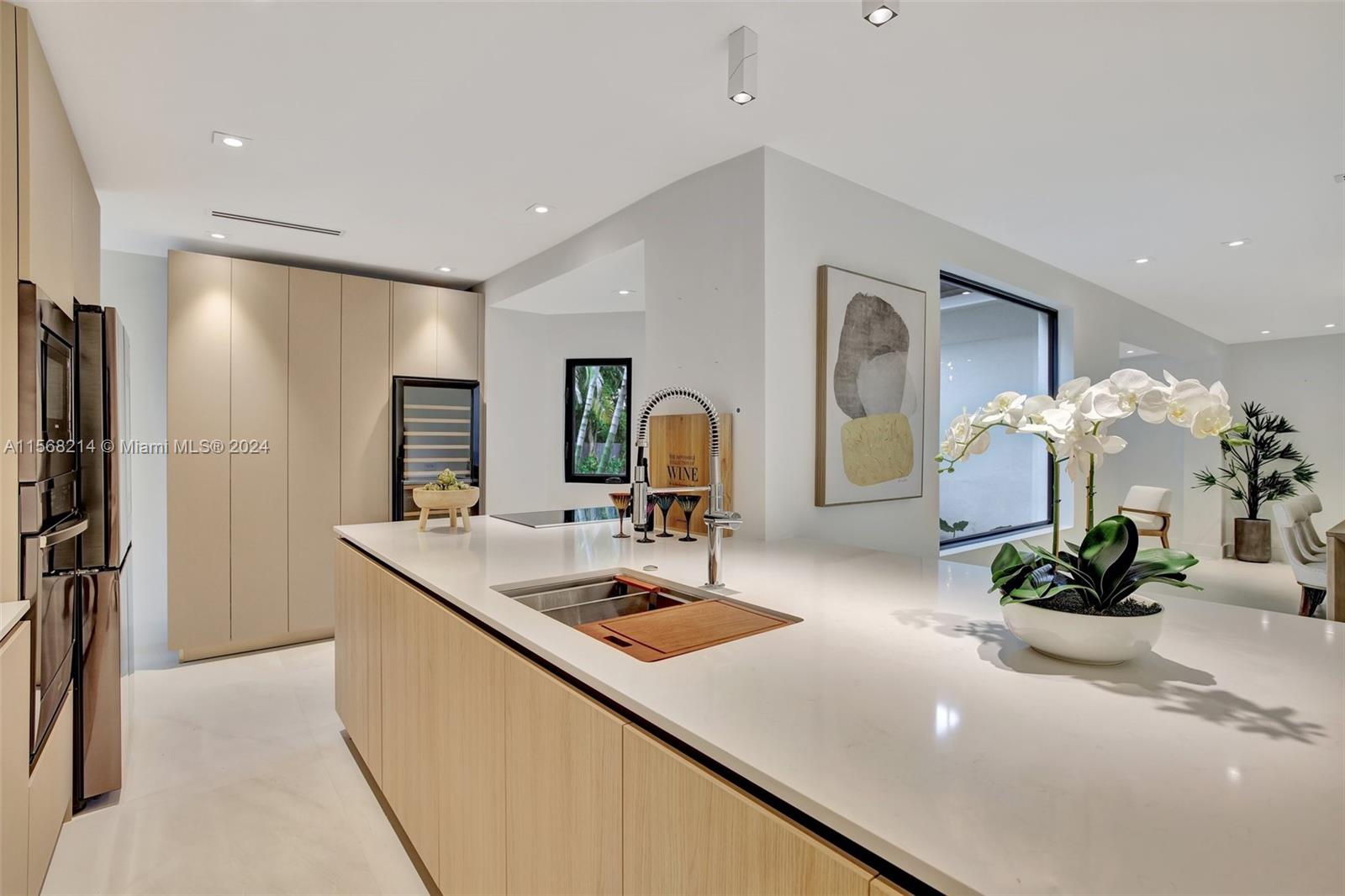 4321 Alton Road Miami Beach, FL 33140 - Photo 19 of 56 a kitchen with a sink and a refrigerator