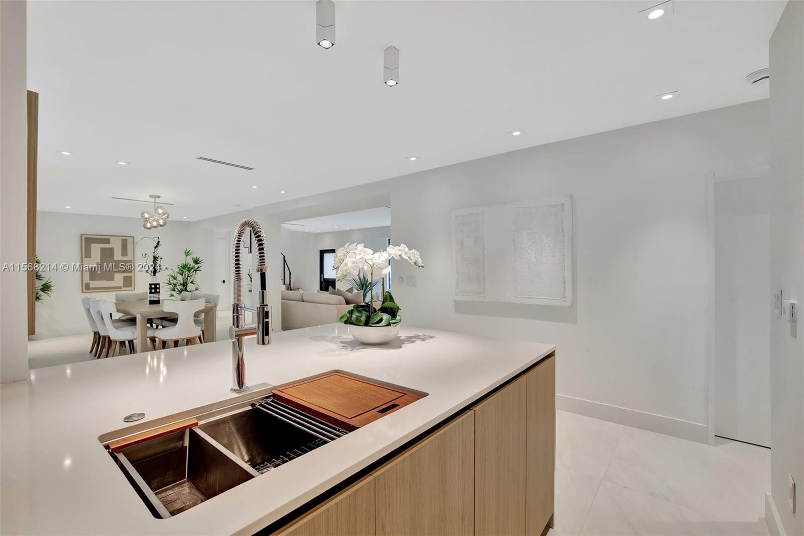 4321 Alton Road Miami Beach, FL 33140 - Photo 20 of 56 a kitchen with stainless steel appliances a sink and cabinets