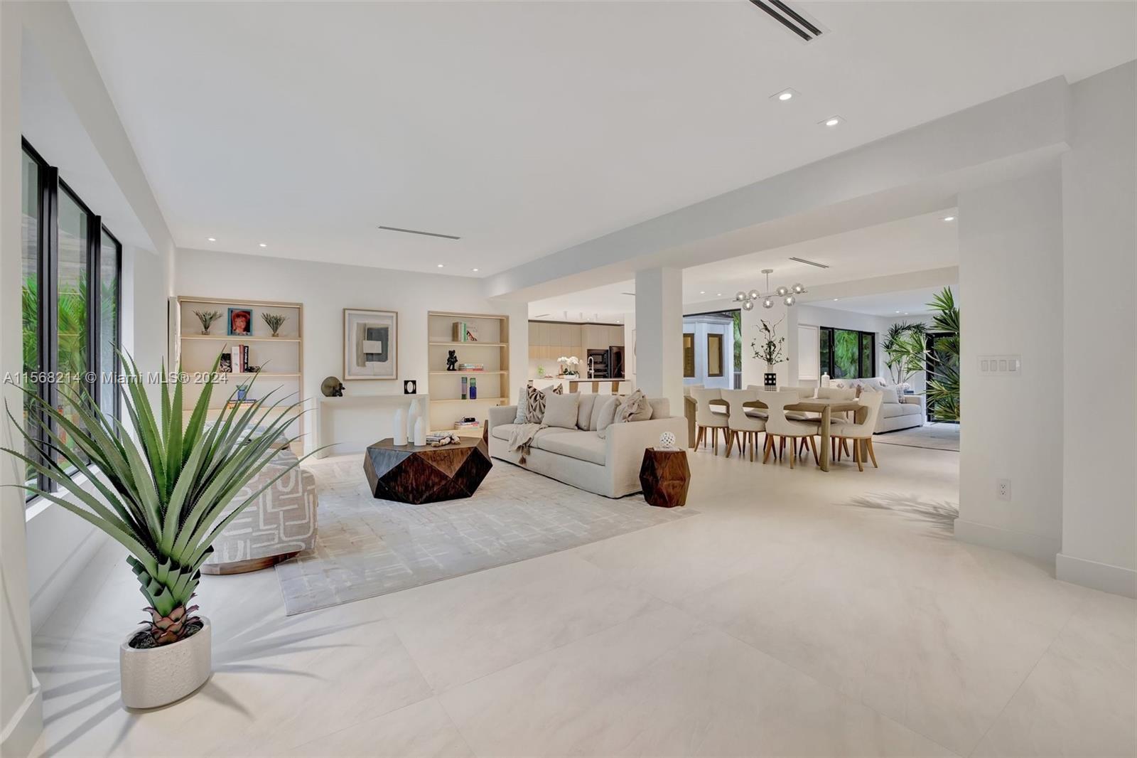 4321 Alton Road Miami Beach, FL 33140 - Photo 2 of 56 a living room with furniture potted plant and a window