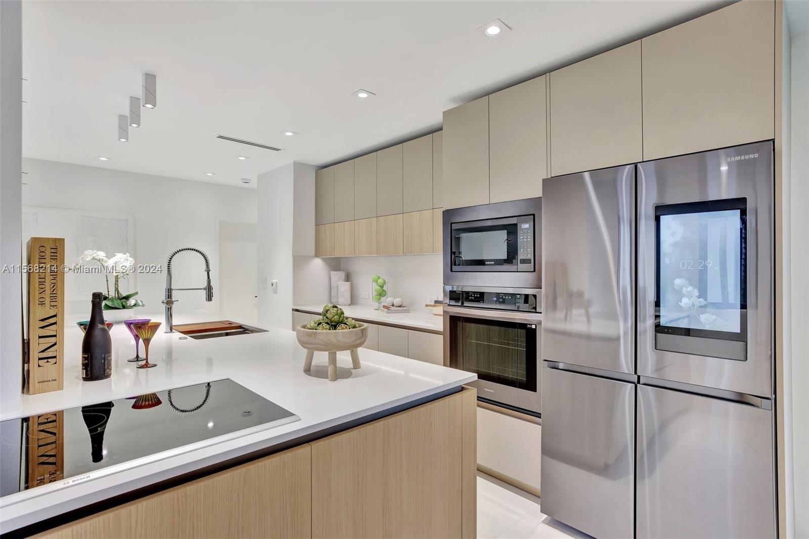 4321 Alton Road Miami Beach, FL 33140 - Photo 22 of 56 a kitchen with stainless steel appliances granite countertop a refrigerator and a sink