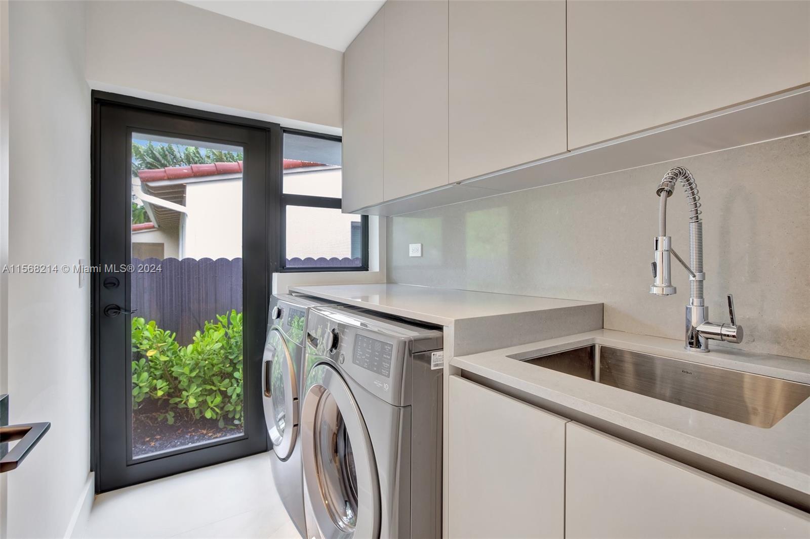 4321 Alton Road Miami Beach, FL 33140 - Photo 23 of 56 a utility room with dryer and washer